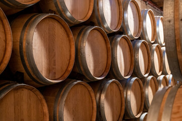 Keeping for years of dry red wine in new oak barrels in caves in Burgundy, made from pinot noir grape