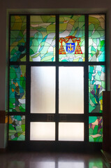 Zakopane, Poland, June 8, 2021: Interior of the Holy Cross Church in Zakopane. Stained glass window around the door with the coat of arms and the invocation of Cardinal Franciszek Macharski