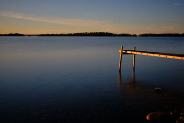 Jetty at a lake at sunset