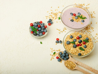 Granola, yogurt, blueberries in bowls on grey background. Healthy breakfast menu concept.