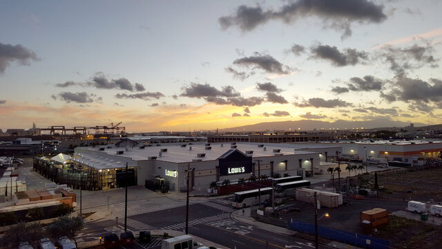 Aerial of dusk over Lowe's and Shipping Cranes with Matson Shipping containers around building