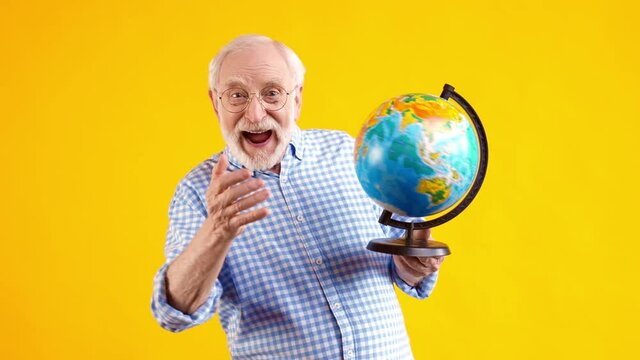 Funky old man roll globe have fun celebrate victory