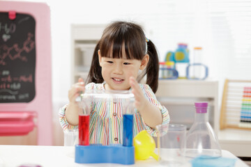 young  girl  play science experiments for homeschooling