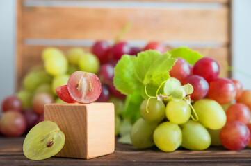 Cut grapes with seeds on a wooden background close-up and copy space...