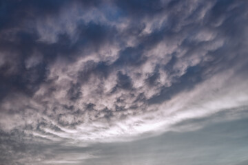 Obraz premium Dark dramatic clouds in the evening sky. Thunderclouds in bad weather. Atmospheric mood. Background for text.