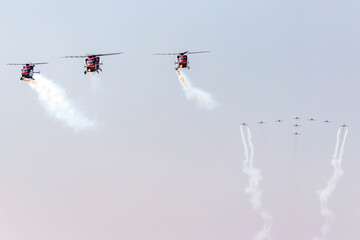 Aerobatic aircraft and helicopters flying together