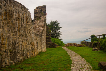 Fototapeta na wymiar TSIKHISDZIRI, GEORGIA: View of the old fortress of Peter in Tsikhisdziri on a cloudy summer day.