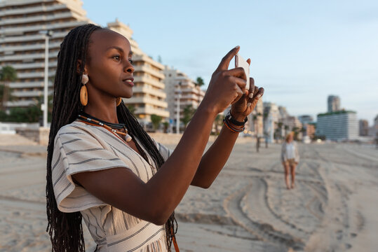 Black female taking photo on resort