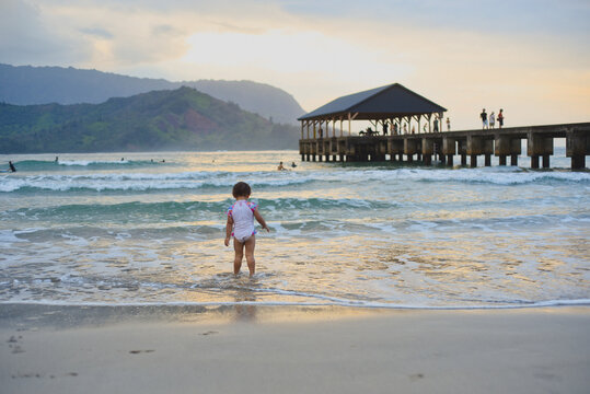 Brave child stands in ocean waves