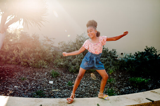 Sun shining on dancing Black girl