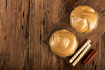 Iced Dalgona Coffee, glass with milk and coffee cream.