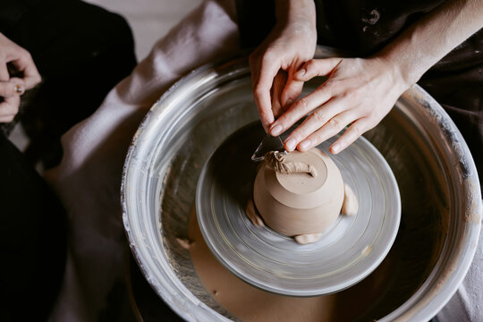 Anonymous artist smoothing pottery by equipment 