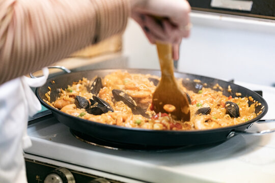 Class: Student Finishing Seafood Paella