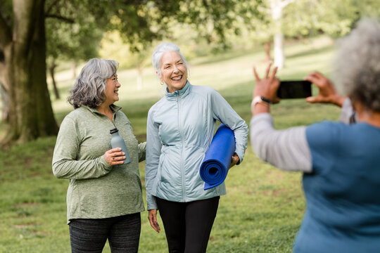 Senior Women Smile While Taking a Picture in the Park