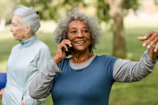 Older Woman Smiles While Talking on her Phone