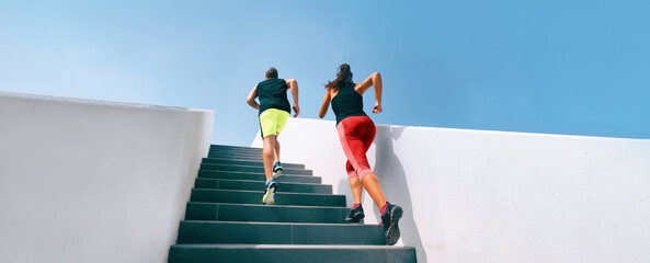 Couple fitness workout two athletes running up stairs sprinting uphill working out dynamic exercise panoramic runners training hiit workout banner.  - obrazy, fototapety, plakaty