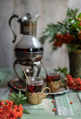 Fresh berries rowan, on wooden background. Ingredient for winter autumn fall seasonal hot drink, immunity alternative medicine beverage.