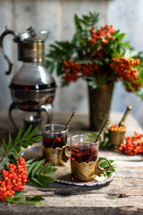 Fresh berries rowan, on wooden background. Ingredient for winter autumn fall seasonal hot drink, immunity alternative medicine beverage.