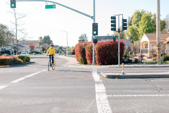 Teenager riding fixie bike and crossing road