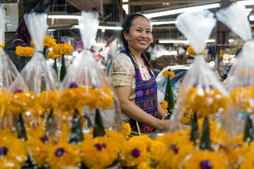 Asian woman works in a Flower market