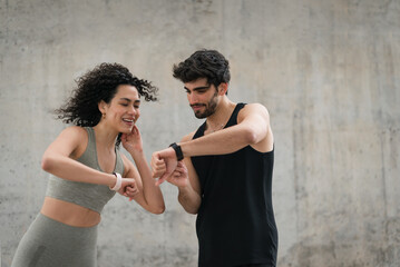 Fit couple using their smart band watch
