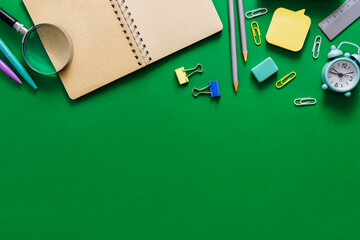 Welcome to school. Office supplies on a green school board. Various school supplies on a shabby...