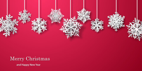 Christmas background of paper snowflakes with soft shadows, white on red background