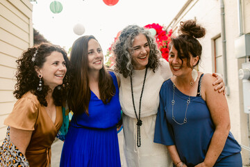 Group of women in dresses laughing together