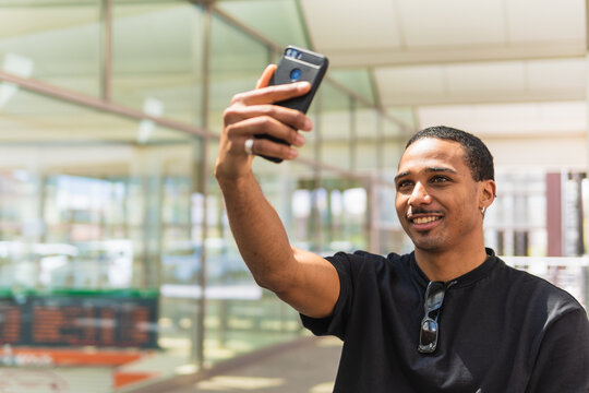 Hispanic man taking selfie on station