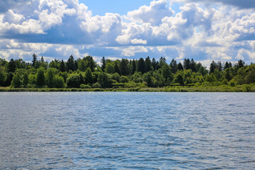 Beautiful natural summer landscape with picturesque lake Senezh and cloudy sky. Moscow region, Russia