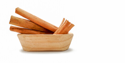 cinnamon sticks in a wooden bowl, with copy space