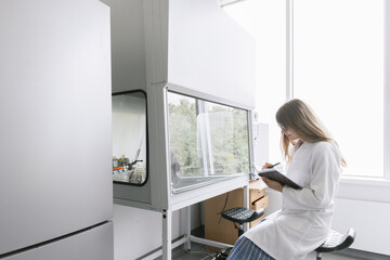 Researcher In The Lab Taking Notes