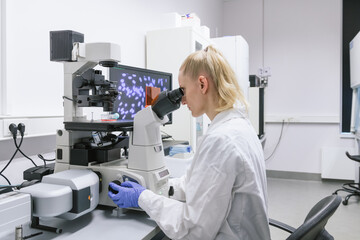Woman Looking At Microscope

