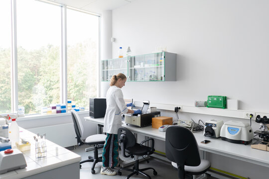 Researcher At Her Workspace In Laboratory