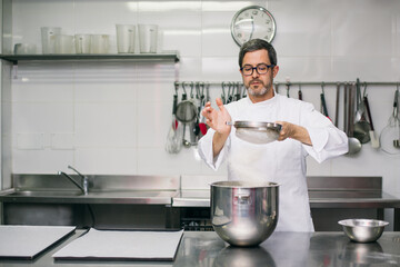 Chef sifting flour into bowl 