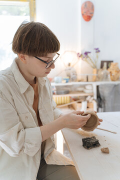 young woman working in a pottery workshop