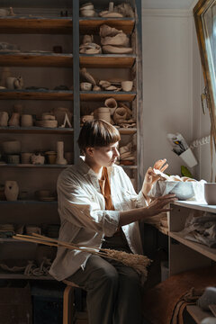 young woman working in a pottery workshop