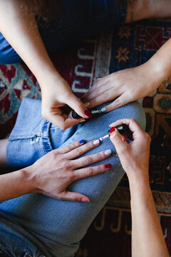 Female hands applying nail polish 