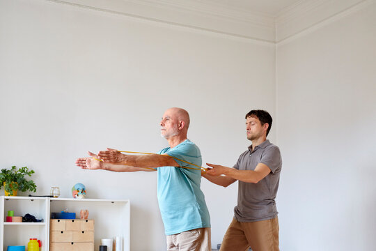 Mature man training with his physiotherapist