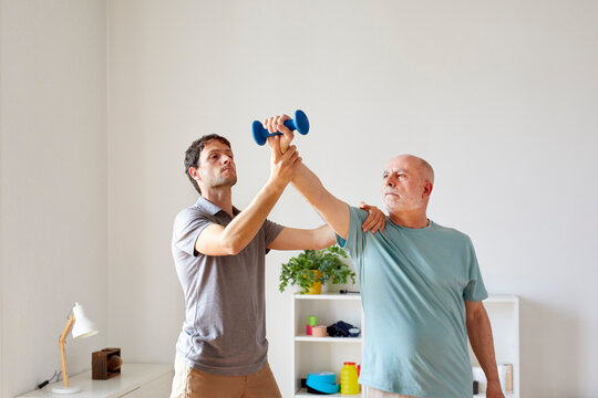 A patient and an osteopath doing exercises