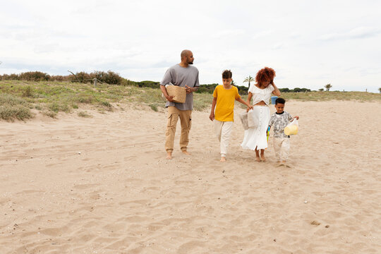 Happy fmily arriving at the beach