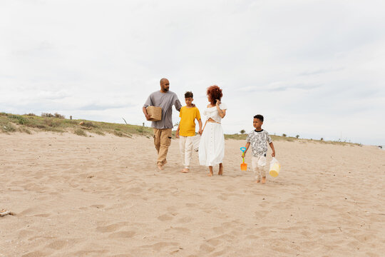 Happy fmily arriving at the beach
