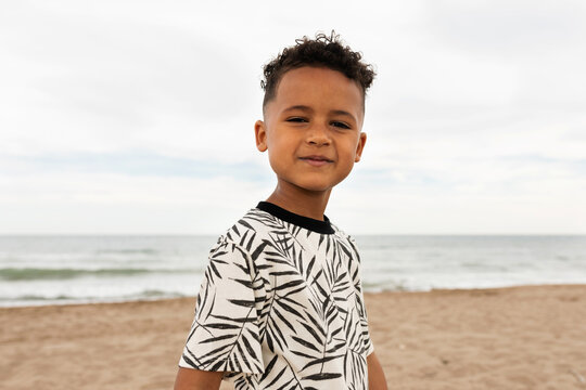 kid doing silly faces on the beach
