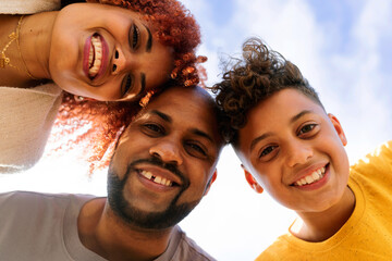 Low angle selfie of smiling black family outdoor