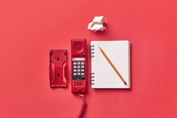 Vitage red telephone handset and notebook
