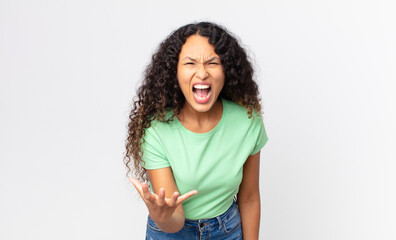 pretty hispanic woman looking angry, annoyed and frustrated screaming wtf or what’s wrong with you
