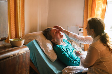 Nursing Senior Woman In The Bed
