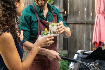 Woman and Man Cheers with Mojitos