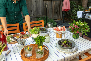 Man Sets Table in Patio
