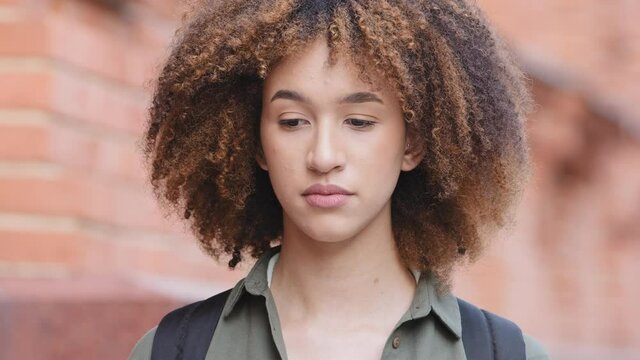 Closeup headshot african american young woman waiting hopefully looking forward, feels deceived frustrated dissatisfaction. Mixed race millennial girl sad because of late, unlucky date, deceit concept
